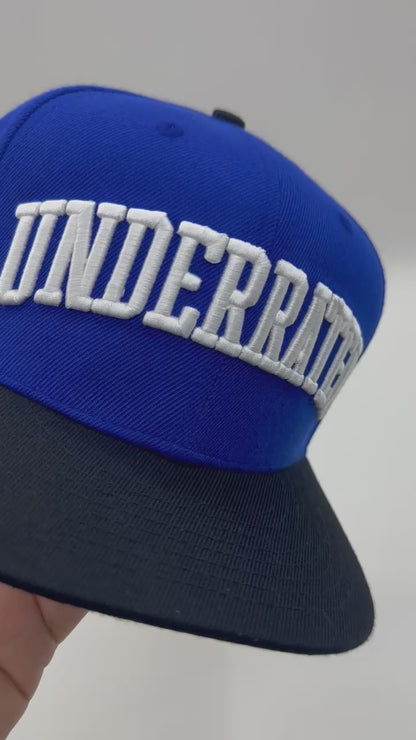“Underrated” Snapback Cap – Royal Blue / Black by KRWN