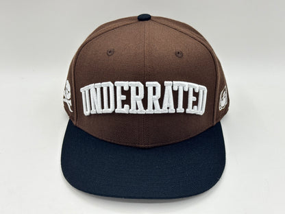 “Underrated” Snapback Cap – Brown / Black by KRWN
