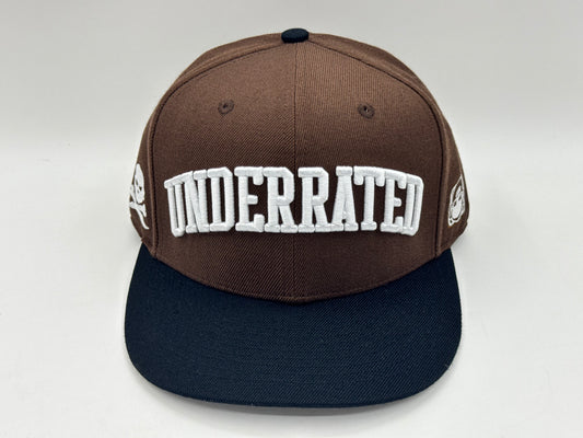 “Underrated” Snapback Cap – Brown / Black by KRWN
