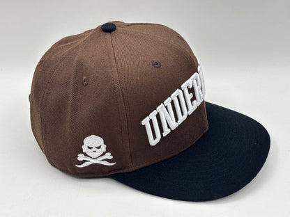 “Underrated” Snapback Cap – Brown / Black by KRWN